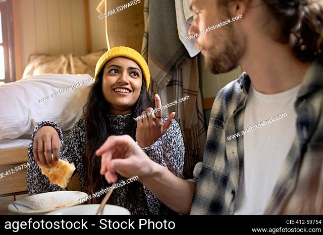 Young couple eating and talking
