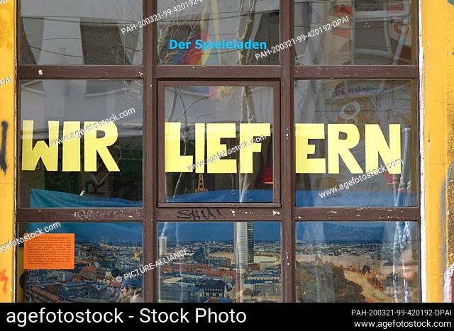 21 March 2020, Saxony, Leipzig: In the shop window of a toy store, the lettering ""We deliver"" is displayed. Photo: Sebastian Willnow/dpa-Zentralbild/dpa