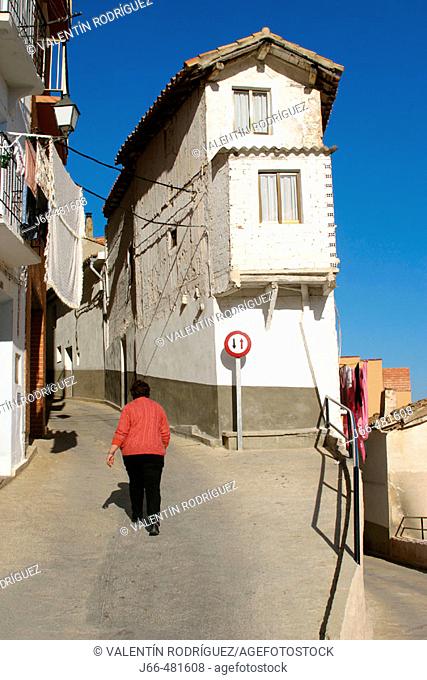 Woman walking on the street. Ademuz. Valencia province. Spain