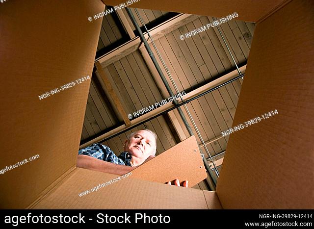 Man looking in cardboard box