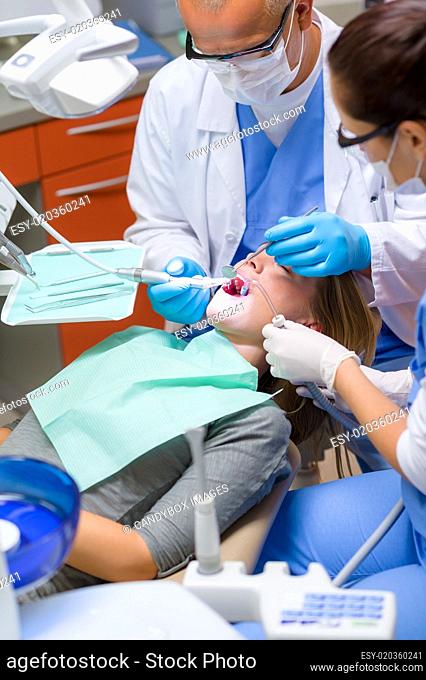 Woman at dentist surgery have teeth treatment
