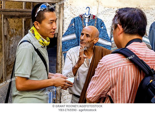 Chinese Tourists Bargaining In The Medina, Fez el Bali, Fez, Morocco