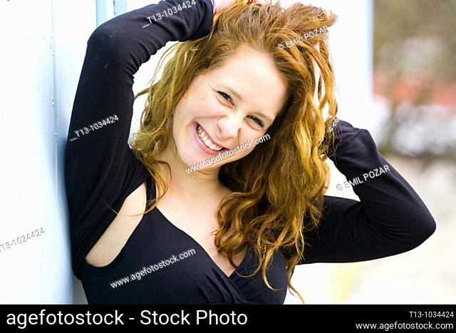 Happy and holding hair attractive young woman portrait