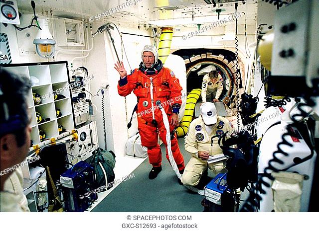 06/02/1998 --- STS-91 Pilot Dominic L. Gorie waves to the camera as he is prepared for entry into the Space Shuttle Discovery by Launch Pad 39A white room crew...