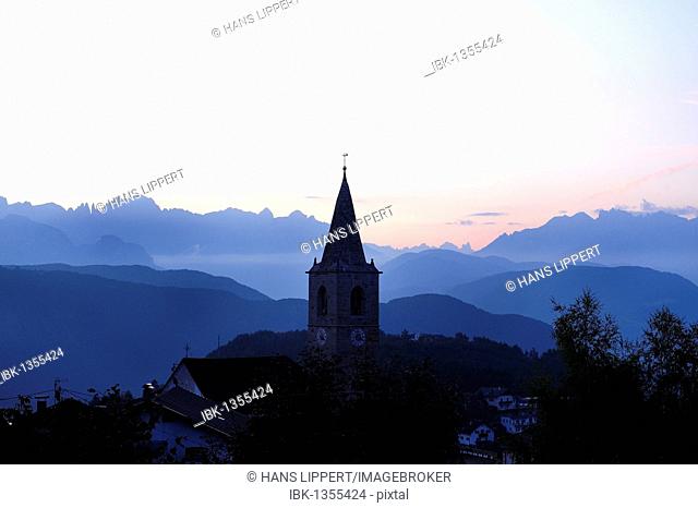 View from San Genesio, located at about 1100m on the Salten high plateau on the southern slope of Mt. Tschoegglberg, on the Dolomites range at sunrise, Bolzano