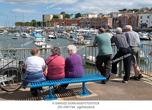 Mature tourists in Paignton marina, Paignton, Devon, UK