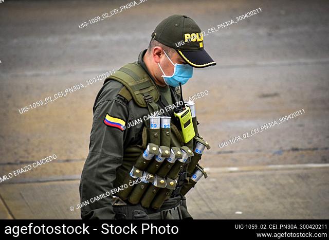 Officer cop walks on the street to arrive at the place where the demostrators prepares the mobilization for the National strike in Ipiales Narino on April 30