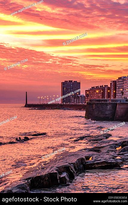 Beautiful urban coastal sunset scene at rambla sur, one of the boardwalks of montevideo city, uruguay