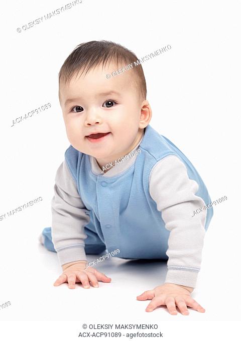 Portrait of a smiling happy seven month old baby boy crawling isolated on white background