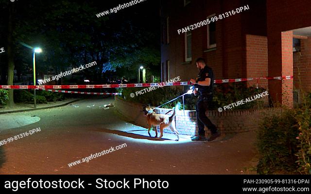 05 September 2023, Hamburg: A police officer searches the area after a knife attack. A 19-year-old allegedly stabbed his uncle several times with a knife on...