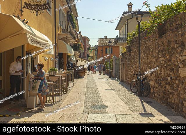 LAZISE, ITALY 16 SEPTEMBER 2020: People walking on Lazise alley