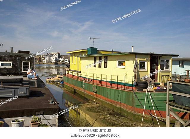 Houseboat moored along the banks of the river adur. Former barges and old boats converted into homes