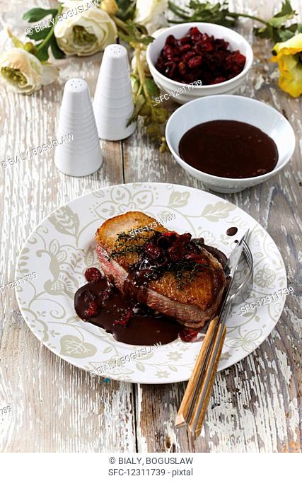 Crispy duck breast in chocolate sauce with cranberries