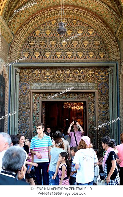 Visitors walk through the entrance portal of the Cathedral of Etschmiadsin, also known as Mayr Tajar Surb Etschmiadsin (the church of the mother of god of Saint...