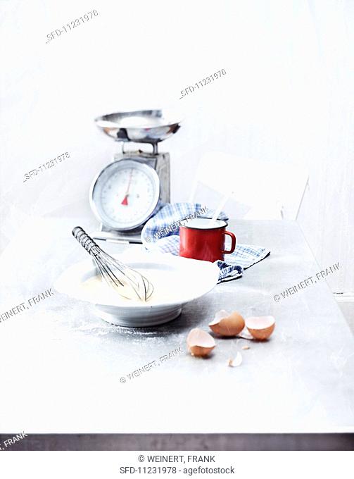 Ingredients for Pfeffernüsse (spiced soft gingerbread from Germany) with kitchen scales and a whisk