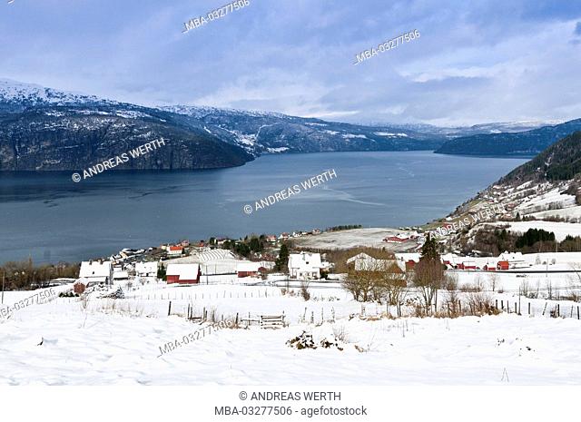View about the Innviksfjord, near Utvik, red timber houses, winter, snowy scenery, Sogn og Fjordane, Norway