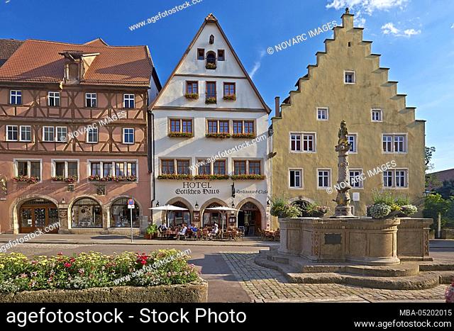 Gothic house in Herrngasse with Herrnbrunnen in Rothenburg ob der Tauber, Bavaria, Germany