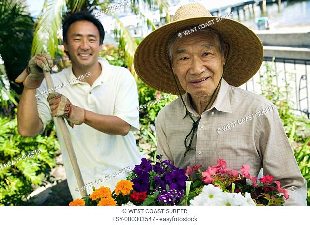 Senior man and son gardening portrait
