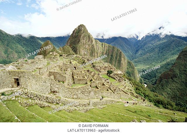 Machu Picchu or Huayna Picchu is an Inca religious and historical archaeoligical site, located on a mountain ridge at 7, 970 ft