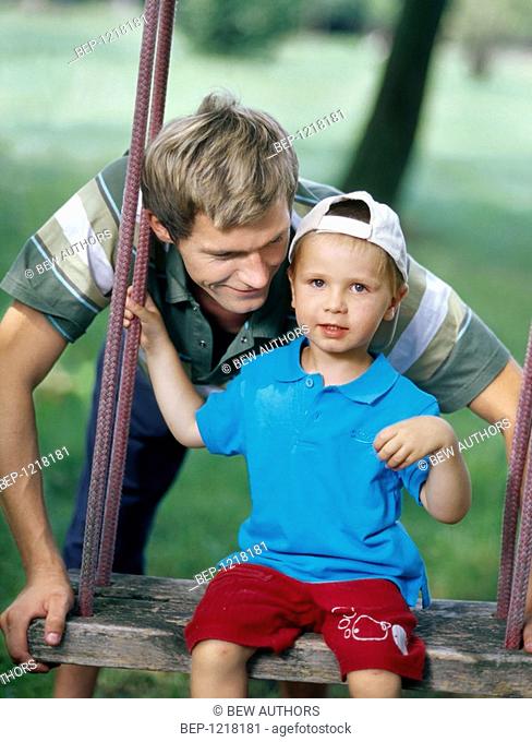 Father with son on the swing