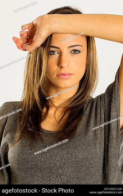 Gorgeous long haired brunette model posing against a white background