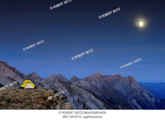 Tent on plateau in front of Alp summits with a full moon, Kaisers, Lechtal, Ausserfern, Tyrol, Austria, Europe