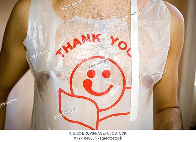 A man wears a plastic shopping bag as a shirt