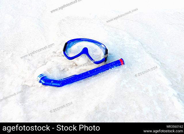 blue mask and snorkel diving on the white sand