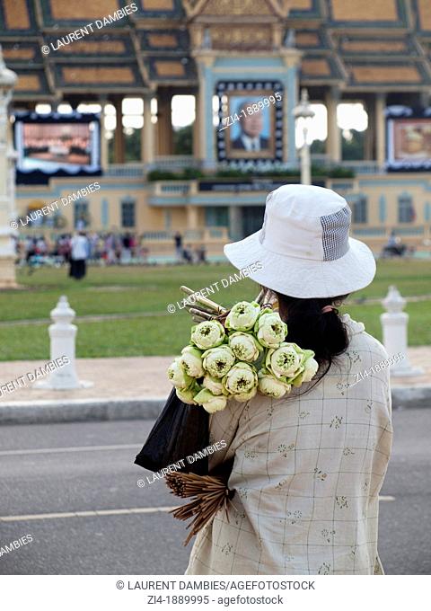 Cambodian woman selling lotus flowers in front of Royal Palace in Phnom Pen during the mourning of King Sihanouk death
