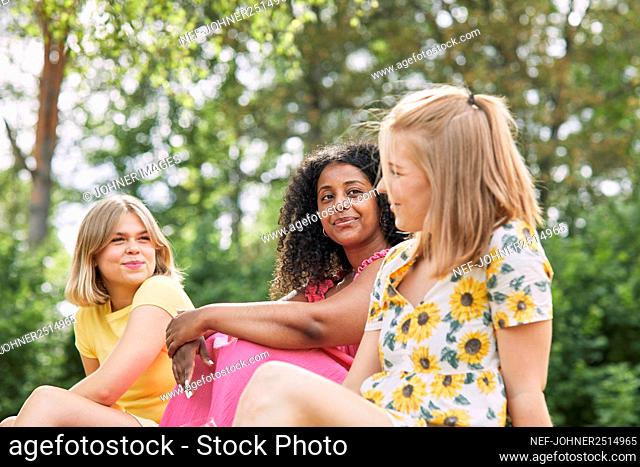 Female friends talking in garden