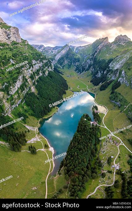View of Seealpsee and the surrounding mountains at sunset. Canton of Appenzell, Alpstein, Switzerland, Europe