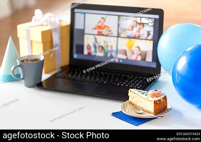 birthday cake and laptop with video call on screen