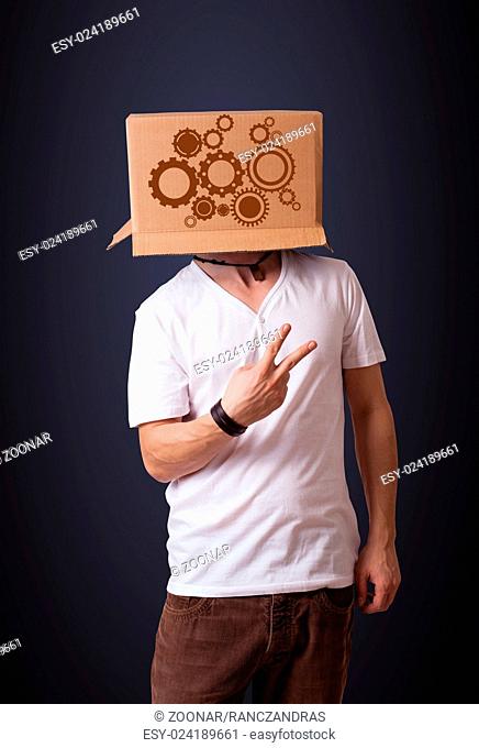 Young man gesturing with a cardboard box on his head with spur wheels