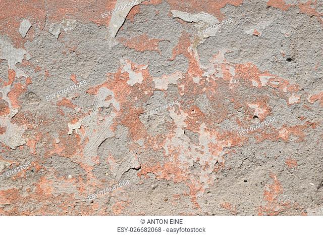 Background texture of old pink painted plaster gray cement wall with grunge stains and paint peeling