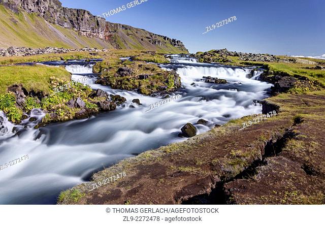 Raging river and waterfalls along Route 1 Fjaorfargigljufur Iceland