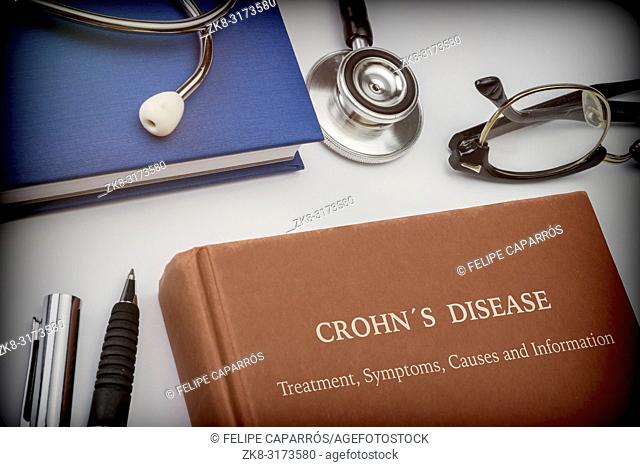 Titled book Crohn's Disease along with medical equipment, conceptual image