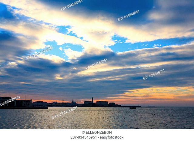 Sunset in the port of Trieste, Italy. Italian panorama. Water and sky