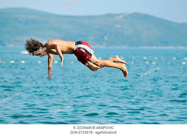 happyfriend boys group have fun and jump in sea at summer vacation