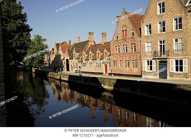Residential house are reflected in a canal in the historic center of Bruges, Belgium, Europe