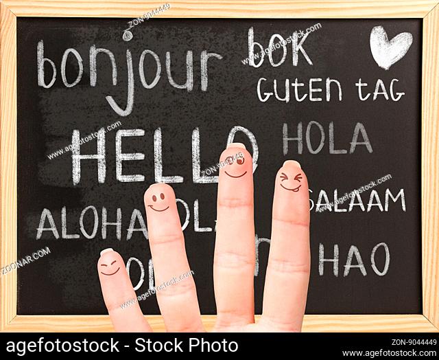 Hello in various languages on a black chalkboard