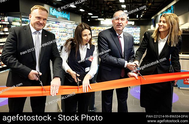 14 December 2022, Bavaria, Munich: Bavarian Minister of Economic Affairs Hubert Aiwanger (Free Voters, 2nd from right) opens the first fully automated Rewe...