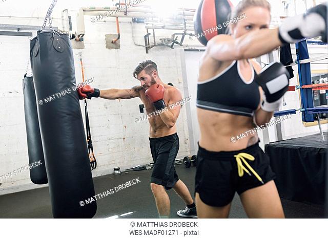 Two boxers exercising in boxing club