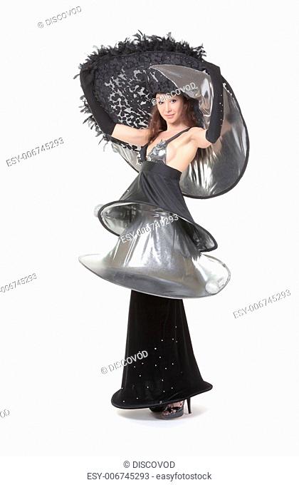 Beautiful young woman dressed in haute couture fashion wearing a modern stylish flamboyant evening outfit in black on a white background