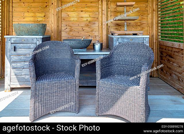 Design of the interior of an outdoor sunshade with a tables, chairs, cabinet and decorations