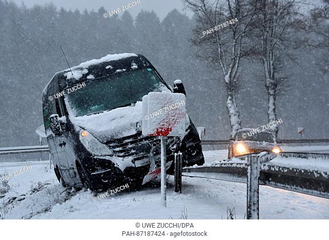 A van got stuck on the crash barrier due to the slippery surface at a federal highway near Mengeringhausen, Germany, 13 January 2017