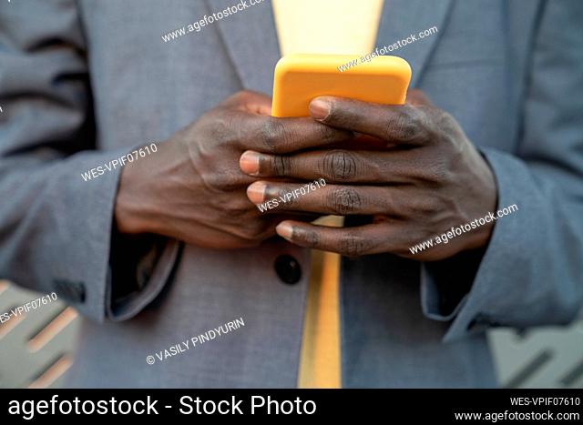 Hands of businessman using smart phone