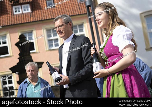02 September 2020, Lower Saxony, Hildesheim: Heiner Wilmer, bishop of Hildesheim, receives the ""tithe"" from the Hildesheim wine convent next to Pauline...