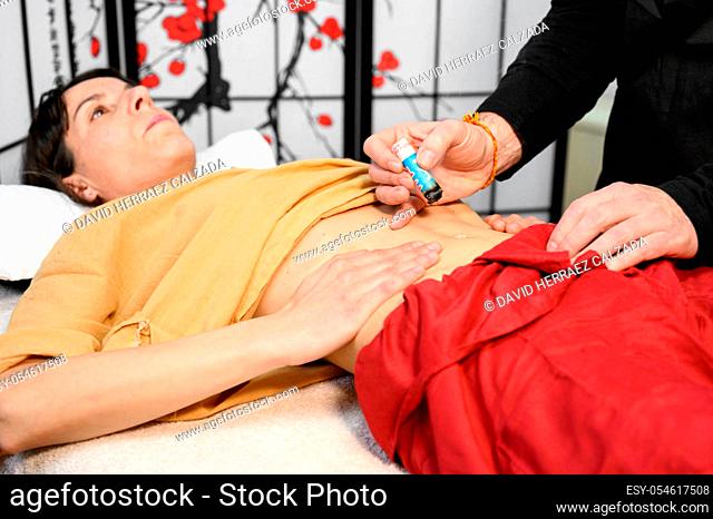 Alternative therapist applying moxibustion a traditional chinese medicine method