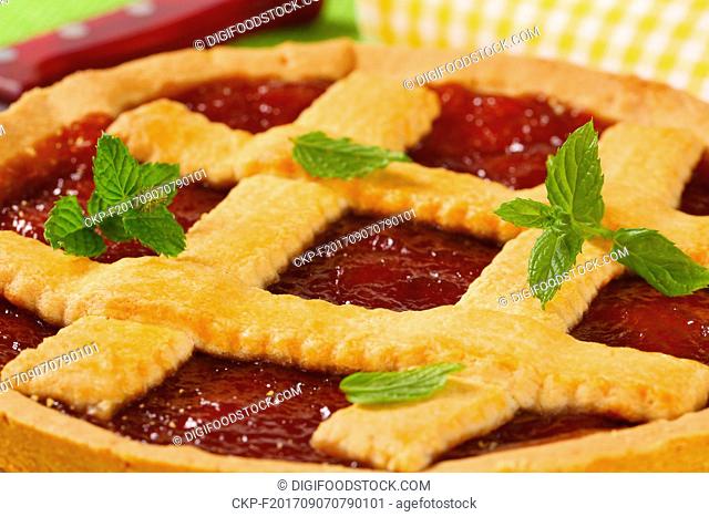 detail of strawberry jam tart with lattice on top
