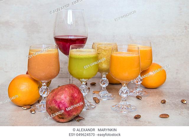 Six fresh juice mix vegetables and fruit, healthy drinks on grey table